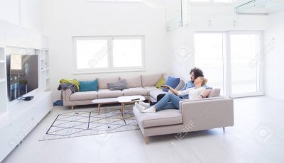 Young couple on the sofa watching television experience home automation